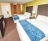 This is a standard hotel room with two double beds a television and basic furnishings