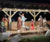 A joyful couple is enjoying a festive night out surrounded by sparkly lights while the woman points at something interesting outside the frame