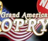 The image shows a stylized golden treble clef against a backdrop of the American flag with the words Grand American Opry and a red circular badge with the word NEW