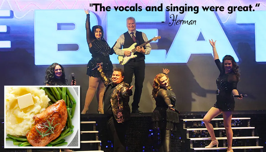 A group of performers is posing energetically on stage in front of a large sign, with a positive quote about their singing and an inset image of a meal featuring chicken, mashed potatoes, and green beans.