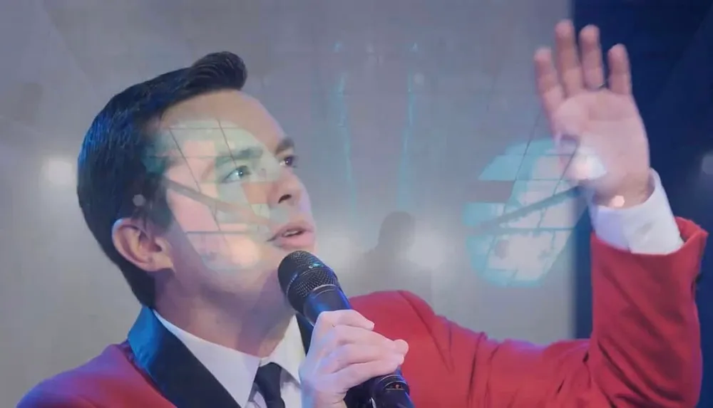 A person in a red jacket is singing into a microphone with an overlay of a geometric pattern