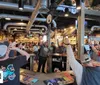 The image features a collage of fun activities including a child playing arcade games people celebrating around a bar a plate of loaded fries and an excited person wearing 3D glasses with the text Triple Play