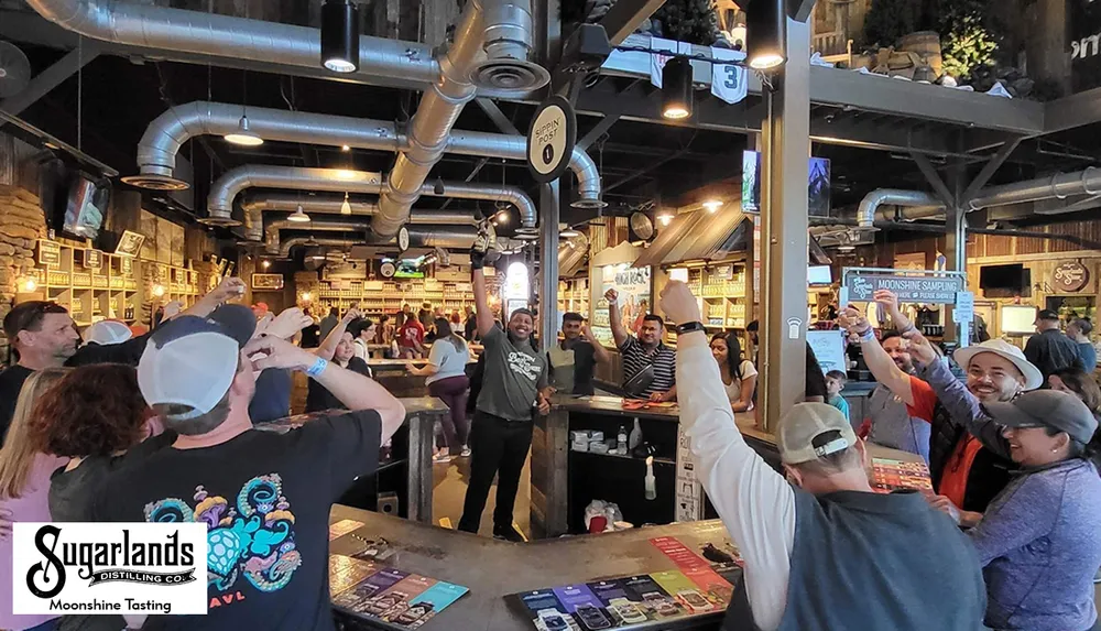 People are gathered inside a distillery enjoying a moonshine tasting event