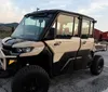 The image features a red and black off-road vehicle with two small insets showing other similar utility vehicles against a natural outdoor backdrop