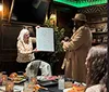 A woman holds up a drawing on a whiteboard during a lively dinner show alongside positive testimonials and an inset of a pasta dish