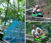 A man and a child are joyfully riding a green mountain coaster on a track surrounded by rocks and greenery