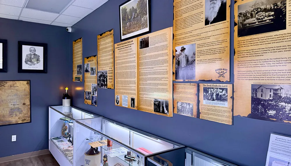 The image shows a museum exhibit with historical text panels photographs and display cases containing artifacts