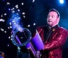 This image is a promotional graphic for the Best Family Magic Show featuring two smiling individuals and mentioning Steven Best Unbelievable Magic along with the endorsement of the International Magicians Society