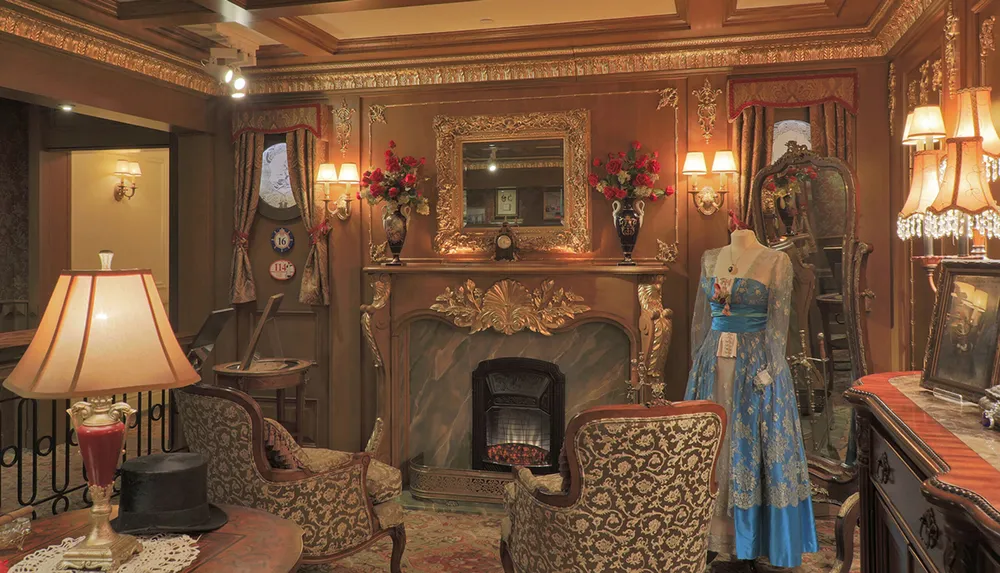This image showcases an opulent vintage-inspired interior with ornate furniture a decorated mantelpiece and a mannequin dressed in an elaborate blue gown