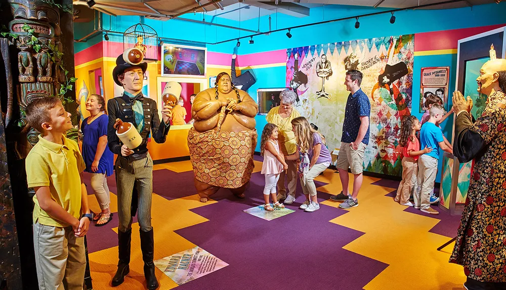 Visitors are interacting with lifelike statues in a colorful museum exhibit