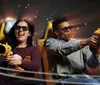 People are enjoying an interactive 3D ride wearing glasses and using handheld devices to aim at targets