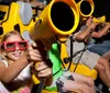 People are enjoying an interactive 3D ride wearing glasses and using handheld devices to aim at targets