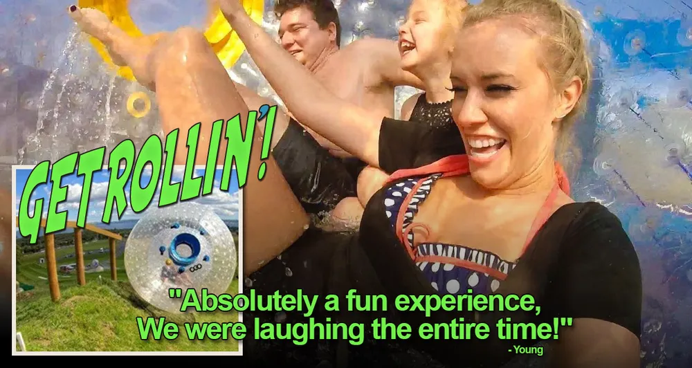 A group of people are joyfully rolling inside a large inflatable ball with text overlay reading GET ROLLIN and a testimonial describing it as a fun experience