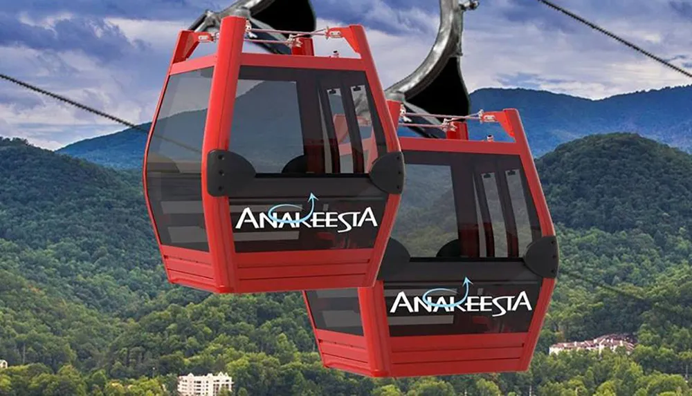 The image shows red gondola cabins of a cable car system against a backdrop of lush green mountains presumably serving as a mode of transportation for sightseeing or accessing mountainous areas