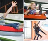 A young girl is joyfully sliding down in an orange Tube Pro water slide tube