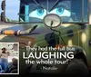 Three jovial men are posing playfully in front of a bus showing a great sense of camaraderie and humor