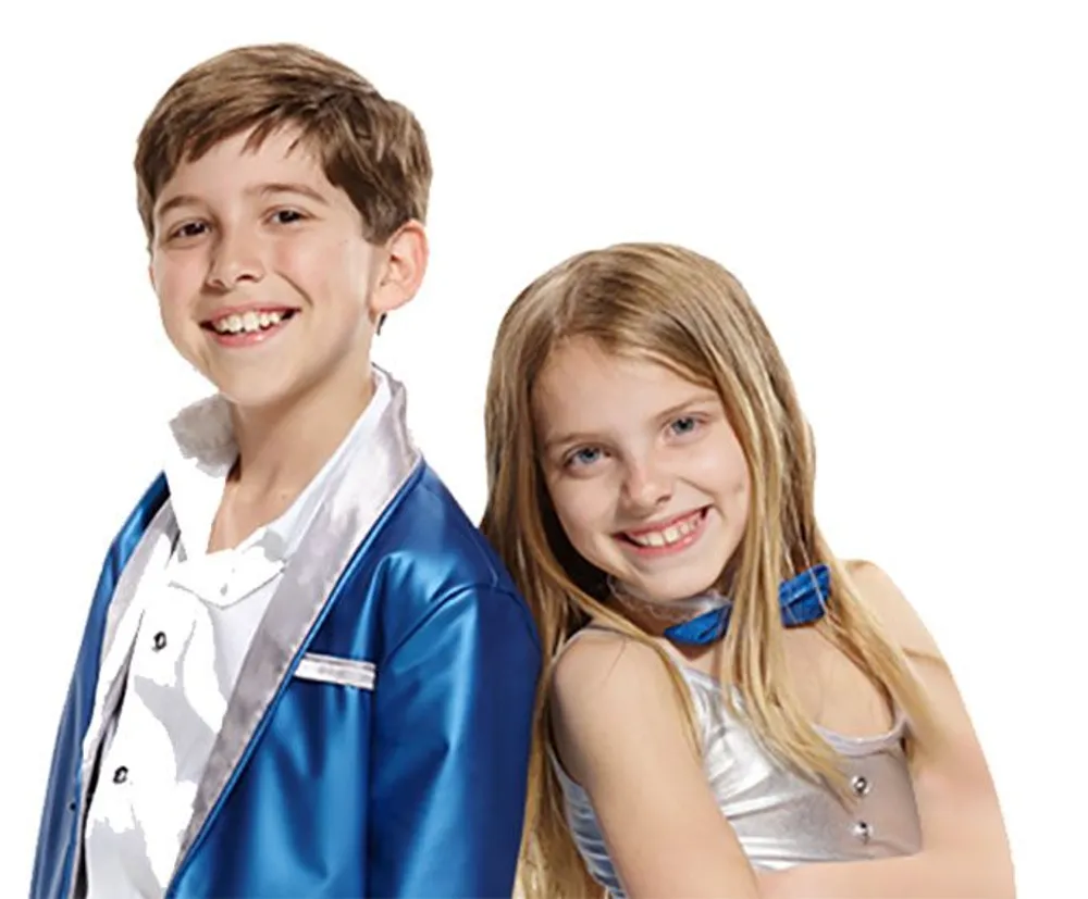 A young boy and girl are smiling in coordinated blue and silver performance attire against a white background