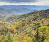 A modified off-road vehicle is parked on a scenic overlook with expansive views of rolling hills and cloudy skies