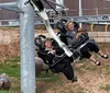 Two people are laughing and enjoying a ride on an amusement park attraction with metal sculptures of buffalo in the foreground