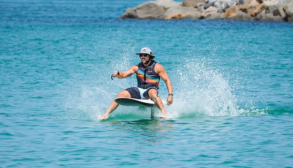 A person is riding a hydrofoil board above the waters surface