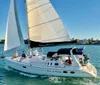 The image shows a group of people enjoying a sunny day on a sailboat named Star of Orion gliding through calm waters