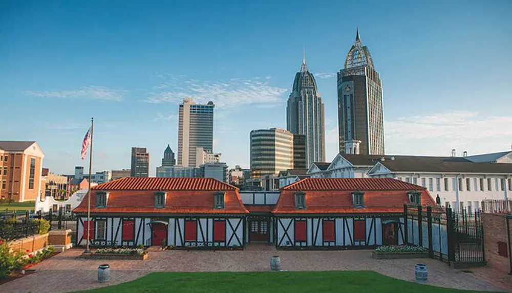 The image shows historic half-timbered buildings in the foreground with modern skyscrapers rising in the background under a clear sky