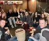 A group of happy people are enjoying drinks together in a cozy lounge with stylish decor