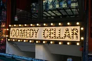The image shows a lit-up marquee with the words 