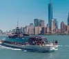 The image shows a ferry full of passengers moving across the water with the skyline of Lower Manhattan including the One World Trade Center in the background