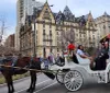 A horse-drawn carriage with passengers is on a city street likely a touristic activity with historic buildings in the background