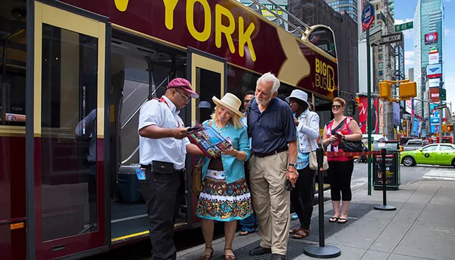 A tour guide is assisting a couple with a map in front of a sightseeing bus in a bustling city area, likely offering them information about local attractions.