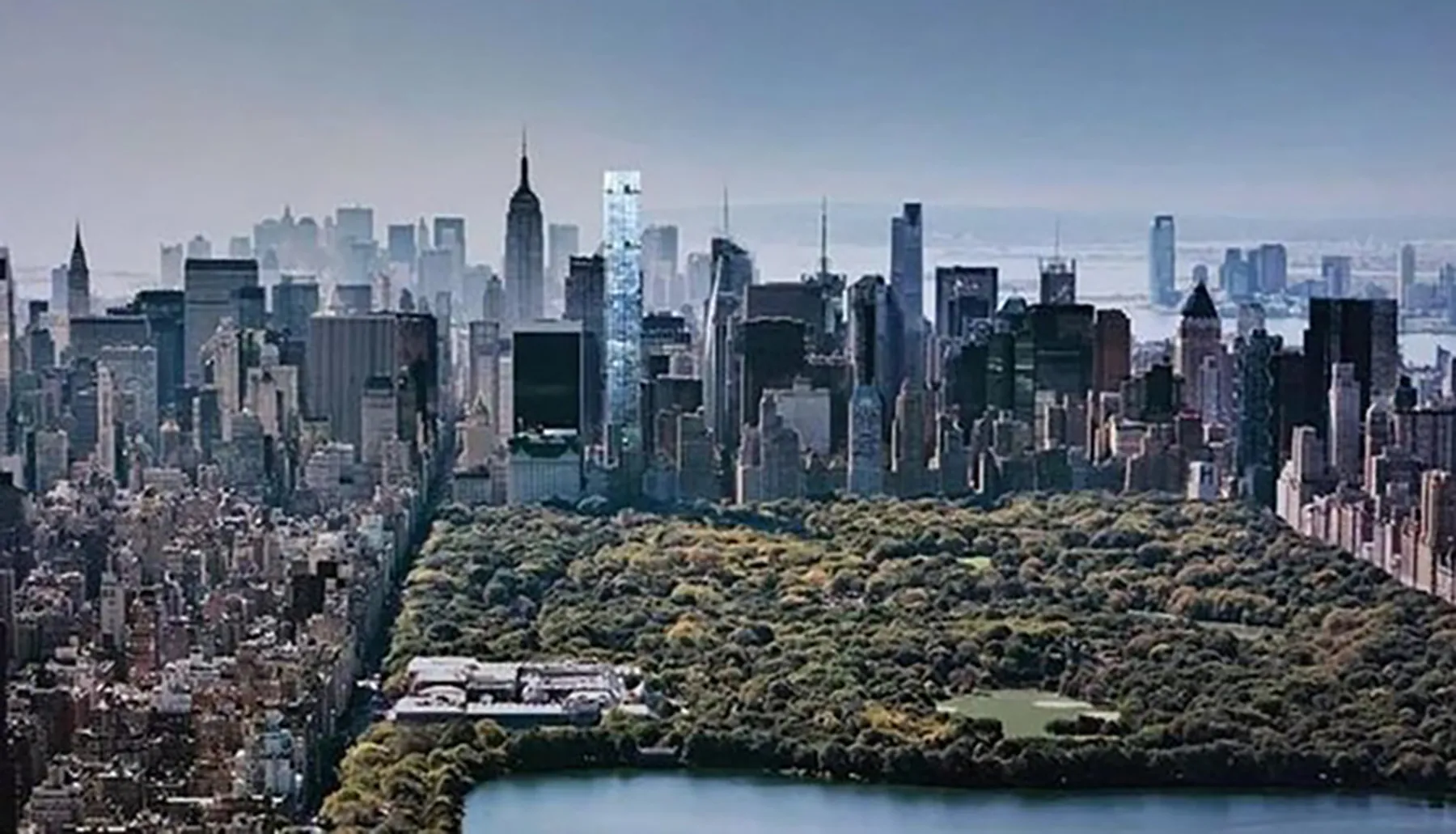 This image showcases a panoramic view of a dense urban skyline with a large park in the foreground, likely Central Park in New York City, contrasting nature with the built environment.