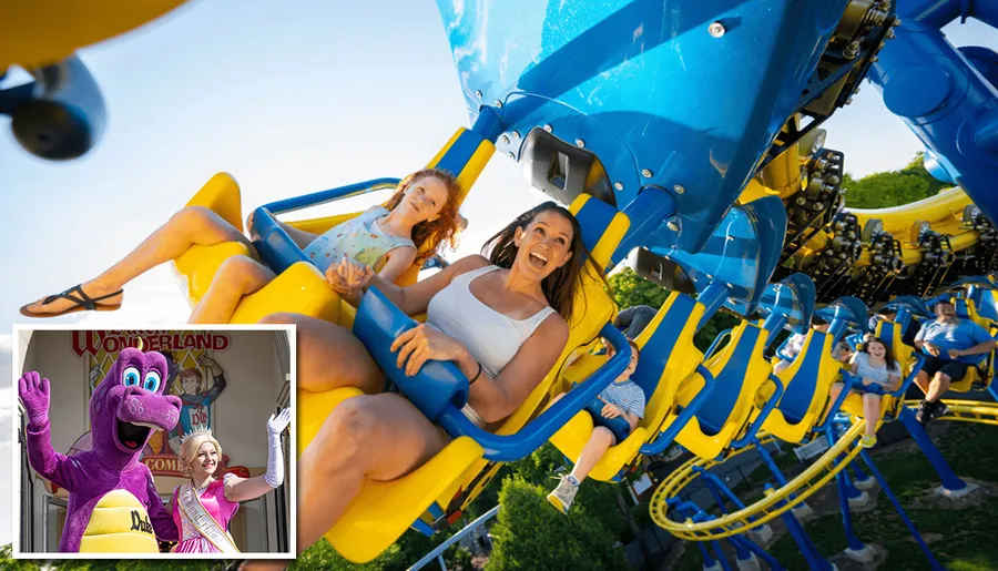 A group of people are joyfully riding a colorful roller coaster, with their faces expressing excitement.