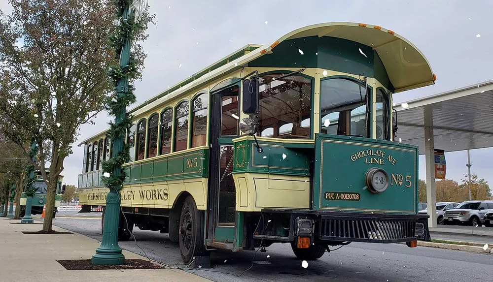 An old-fashioned trolley labeled Hershey Transit suggesting a historical or tourist transport is parked on a city street with festive decorations