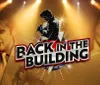This image is a promotional graphic featuring silhouettes and images of a male and a female performer with spotlights and the title BACK IN THE BUILDING in bold lettering suggesting a musical or entertainment event
