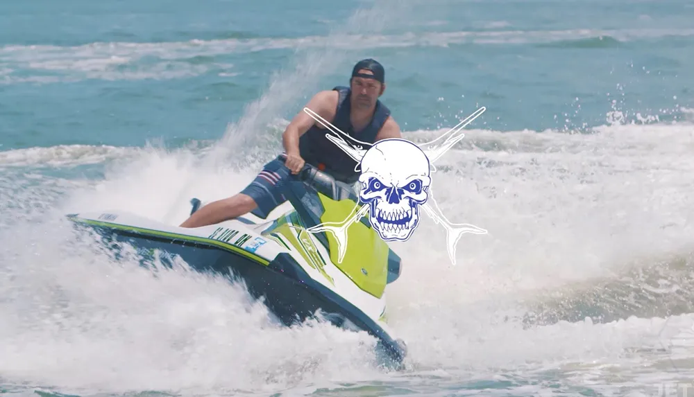 A person is riding a jet ski on choppy water with a stylized skull and crossbones graphic superimposed on the image