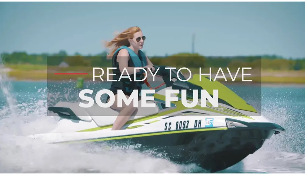 A person is riding a jet ski on a sunny day with the overlaid text READY TO HAVE SOME FUN suggesting a leisure or vacation theme