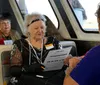 Three women dressed elegantly are sitting around a table on a boat enjoying the view and each others company with quotes about having an awesome time and a beautiful sunset
