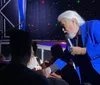 The image promotes a Kenny Rogers  Friends tribute show featuring a person with white hair and a beard dressed in a vest and shirt