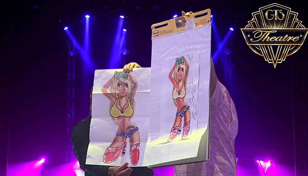 Two people on stage hold up sketches of a cartoonish character in a bikini with a bow against a backdrop of purple lights and a GTS Theatre logo