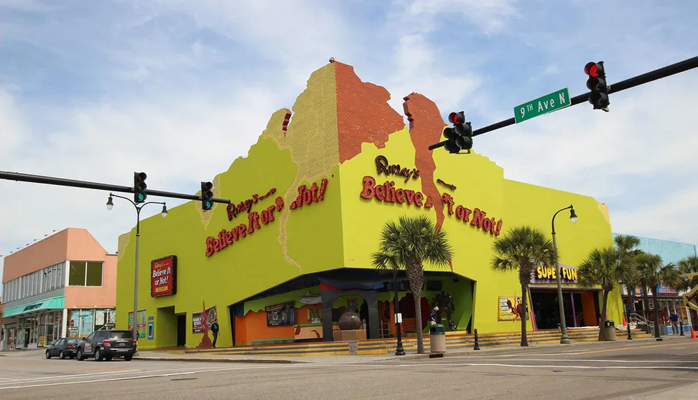 The image shows the facade of a colorful Ripleys Believe It or Not Odditorium with its distinctive architecture and signage located at the intersection of a street marked 9th Ave N