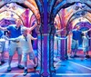 A family poses for a playful photo with a large 3D King Kong exhibit as though they are being attacked