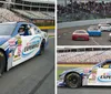 A person wearing a racing helmet is sitting inside a NASCAR race car adorned with sponsor logos parked on a track with grandstands in the background