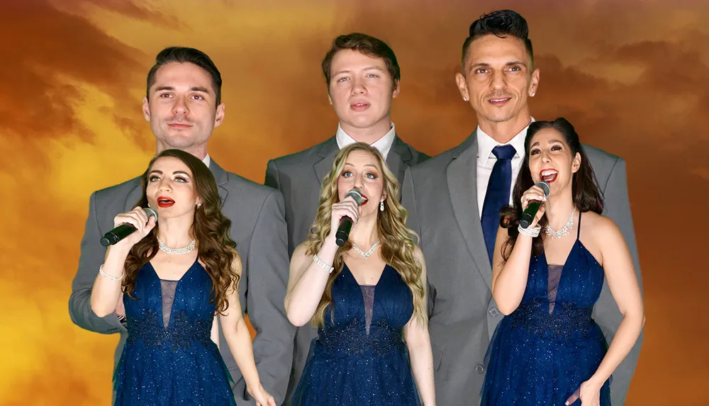 Three couples dressed in formal attire appear to be singing or speaking into microphones against a backdrop depicting a dramatic sunset sky
