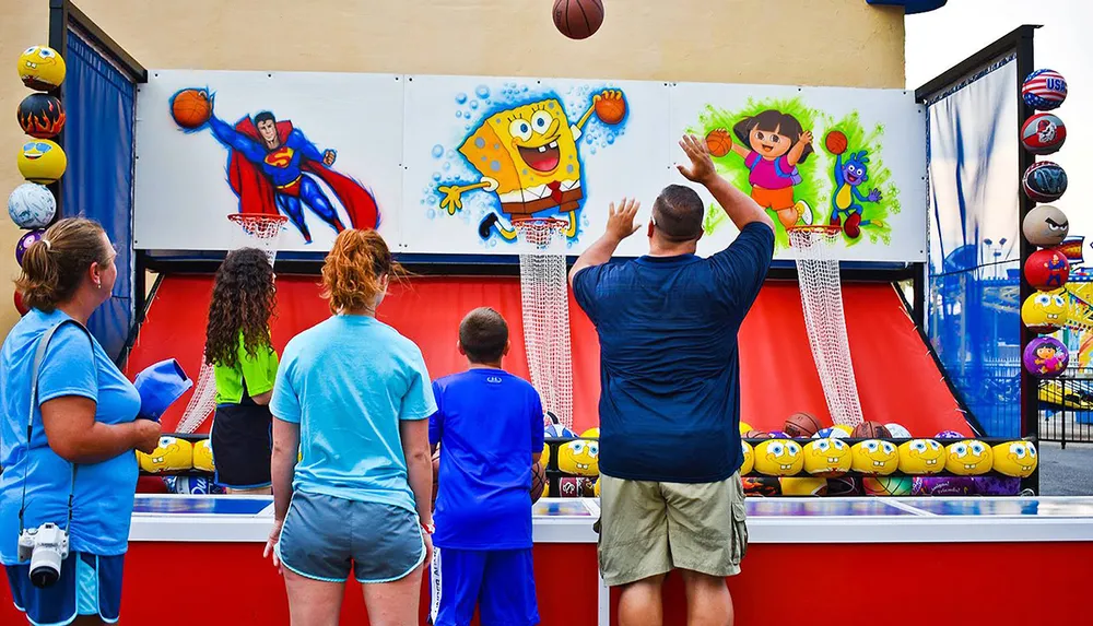 People are playing a basketball shooting game at a carnival with prizes featuring popular characters on display