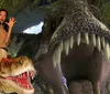 Three people appear to be playfully interacting with a Tyrannosaurus rex in a staged jungle setting