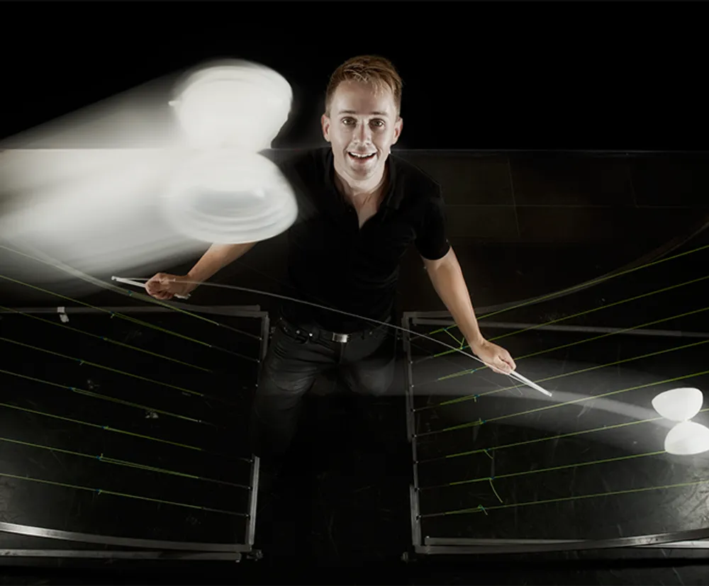 A person is standing behind a barrier with dynamic lighting and motion blur effects creating an energetic scene