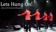 Four performers in red jackets are entertaining an audience on stage during a Frankie Valli tribute show.