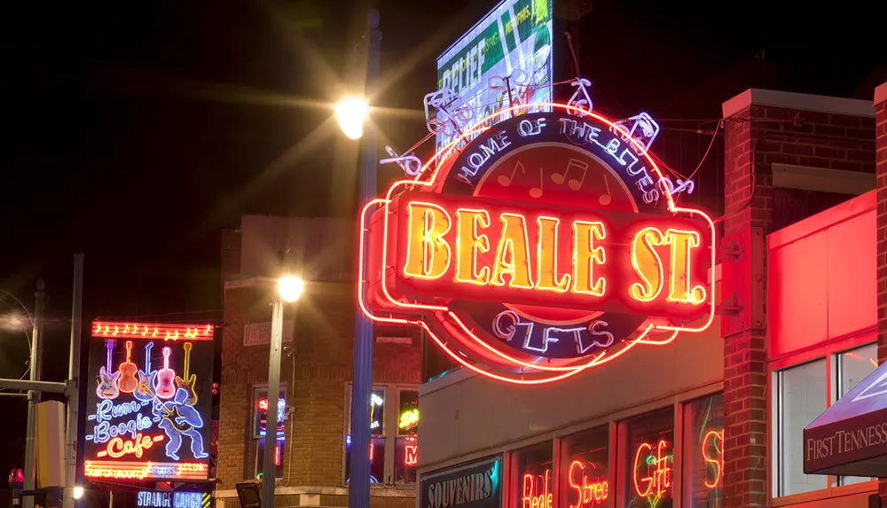 The image shows the neon-lit signs of Beale Street in Memphis at night glowing vibrantly and highlighting the streets association with the blues