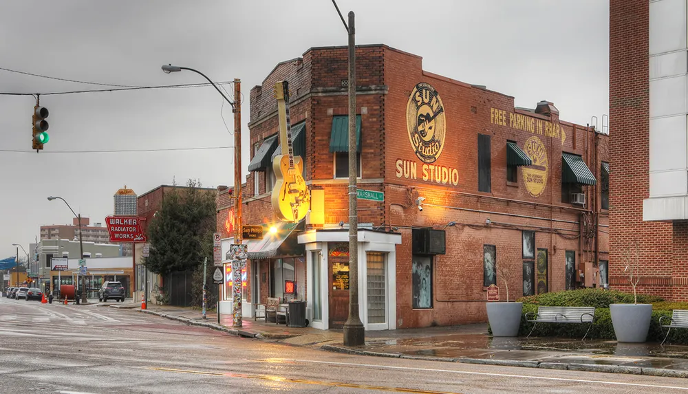The image captures the iconic Sun Studio in Memphis known for its significant contribution to the birth of rock and roll on a cloudy day with wet streets